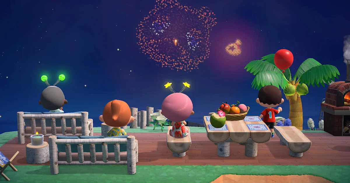 Four players sitting on log benches beside a fruit-covered picnic table, watching fireworks burst over the sea at night in Animal Crossing New Horizons