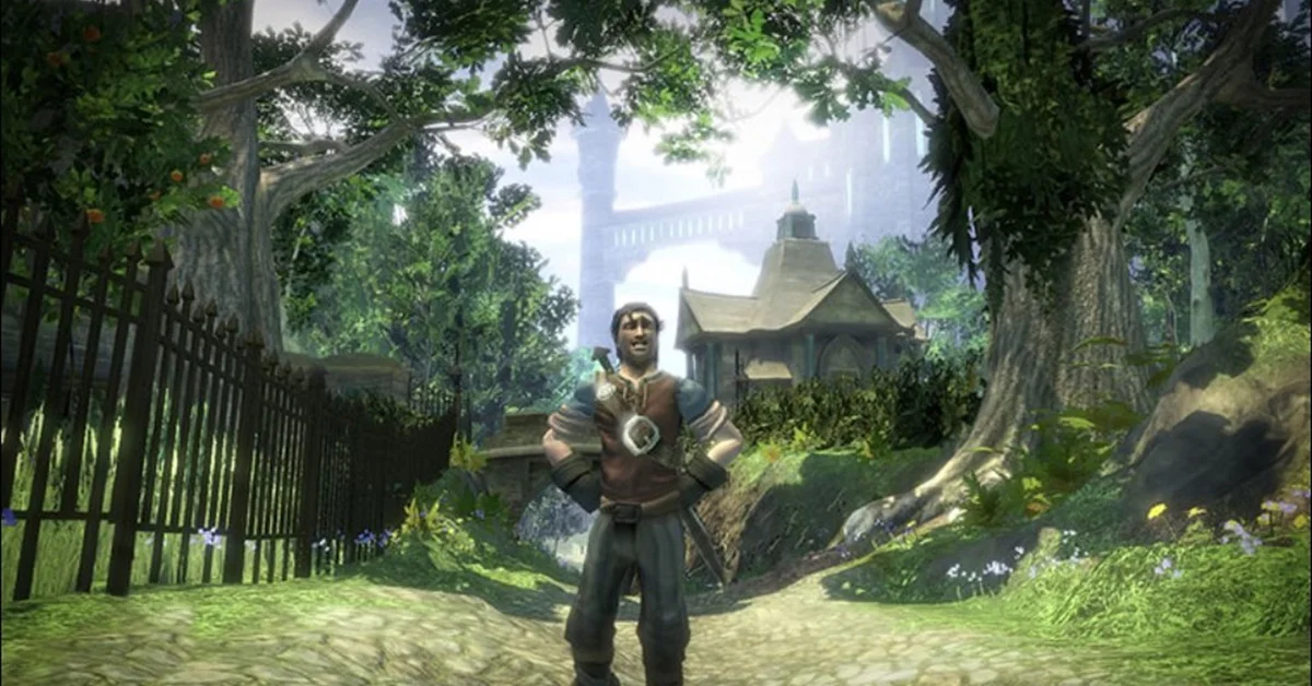 The Fable II hero standing with hands on hips on a sunny village path lined with trees and an iron fence