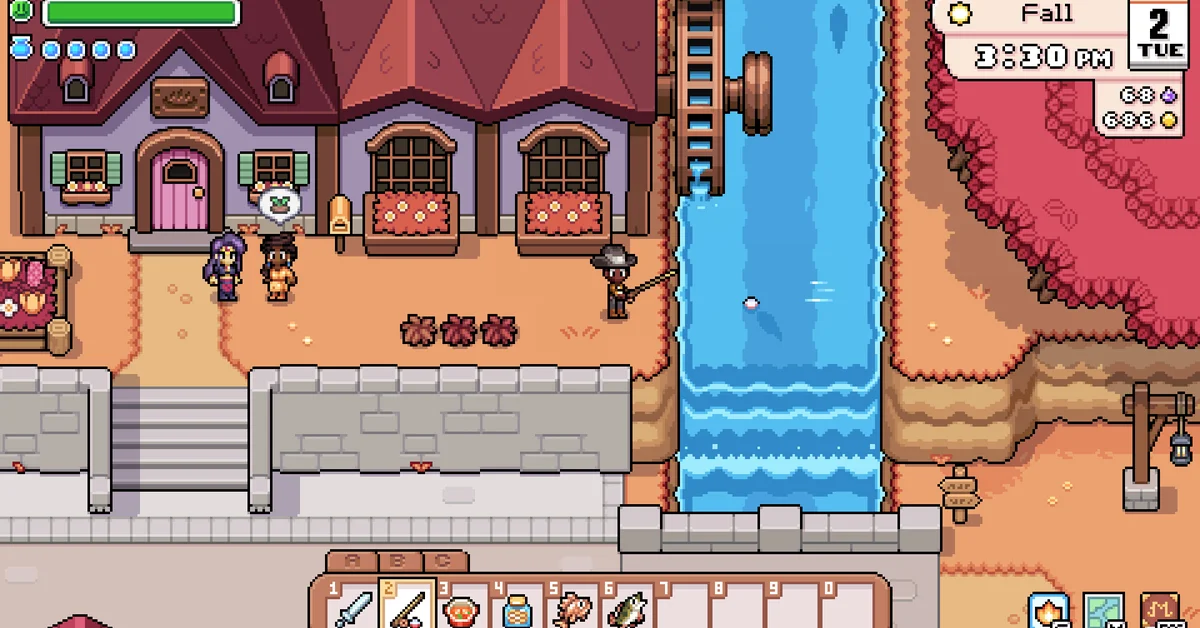 Player character in a wide-brimmed hat fishing from a riverbank beside a water wheel in autumn, with two villagers chatting outside a shop in Fields of Mistria