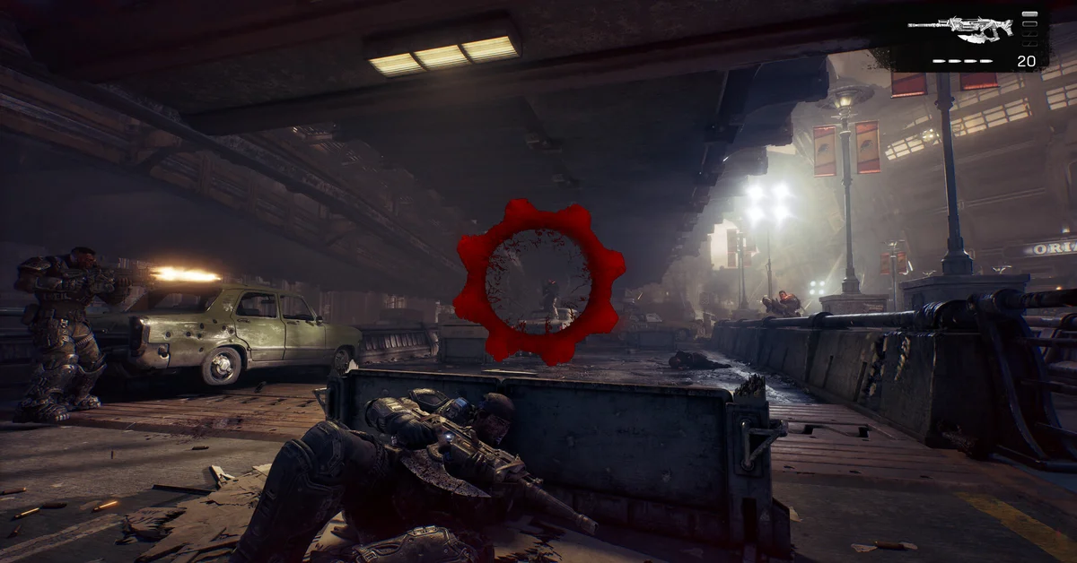 A soldier crouched behind a concrete barrier as a red Omen symbol fills the center of the screen in Gears of War E-Day