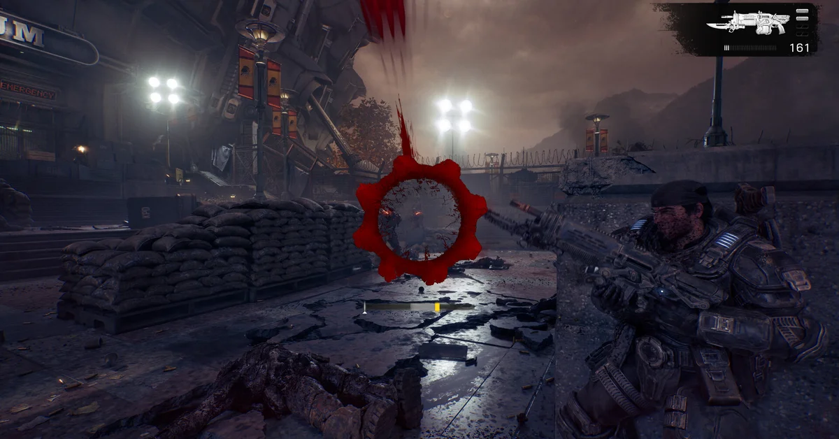 An armored COG soldier aims a rifle from behind a concrete wall on a rain-slicked city street as the red Crimson Omen damage indicator fills the screen