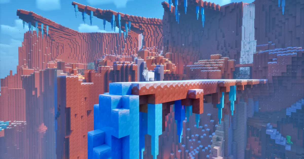 A frozen red-rock canyon in Minecraft Dungeons II with icicles hanging from a stone bridge and a goat standing on top