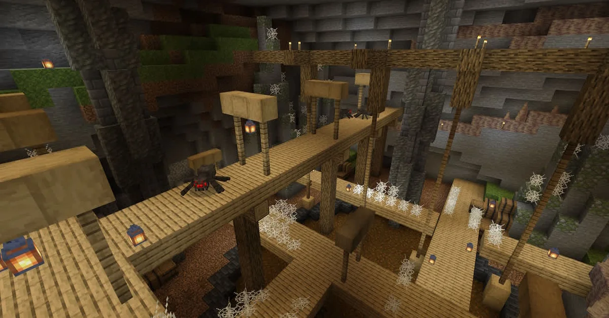 Wooden mineshaft walkways lit by lanterns stretch across a huge cave full of cobwebs, with cave spiders crawling along the planks in Minecraft