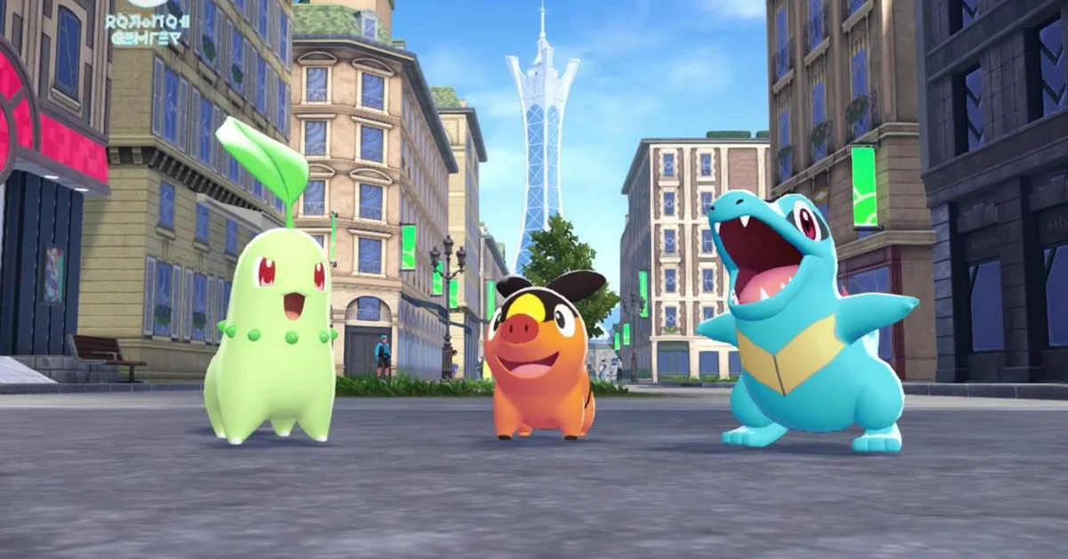 Chikorita, Tepig and Totodile standing on a Lumiose City street with Prism Tower behind them in Pokemon Legends Z-A