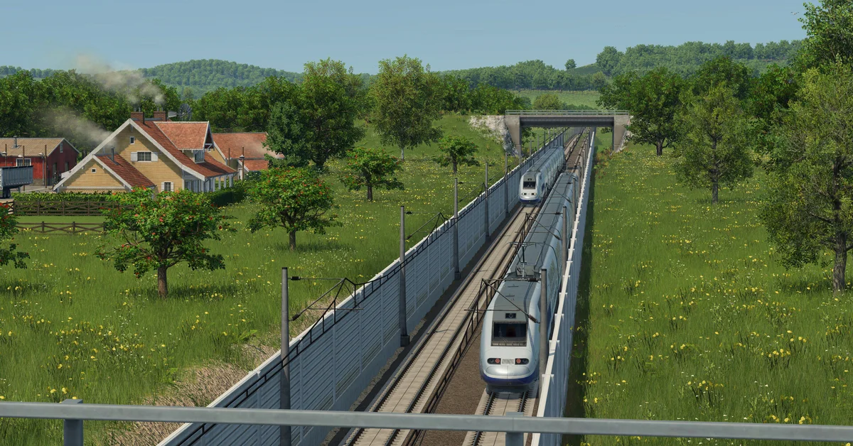 A high-speed train on a fenced line running through green countryside in Transport Fever 3