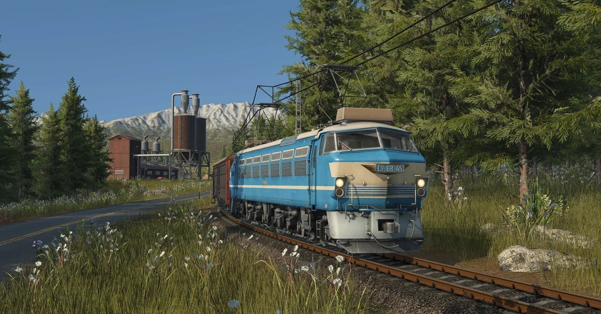A blue diesel locomotive hauling freight in Transport Fever 3