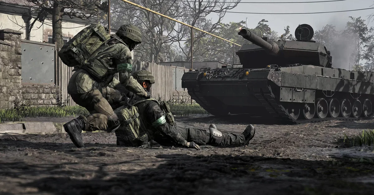 A WARDOGS medic kneels to revive a wounded teammate beside a tank