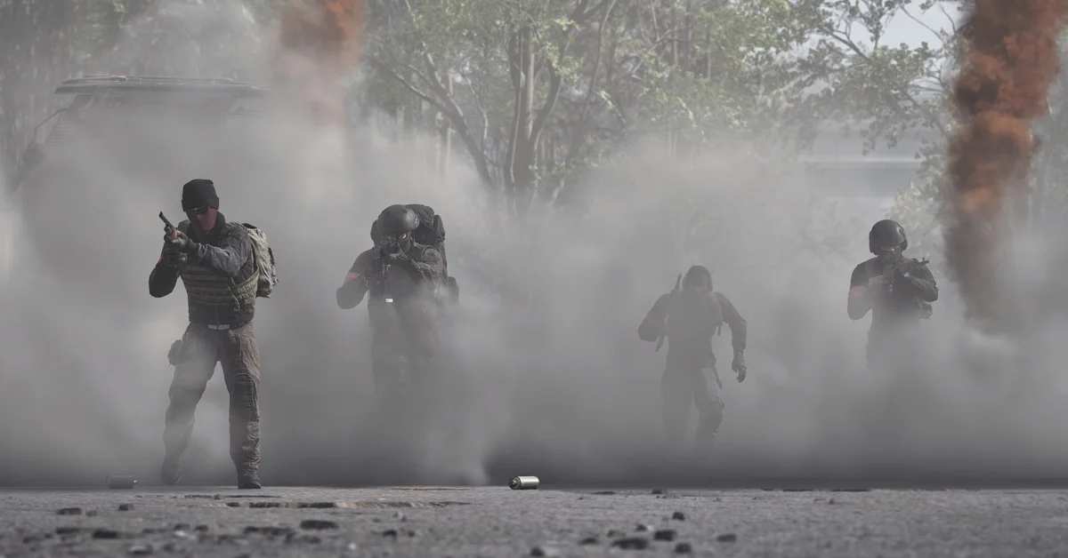 A squad of WARDOGS soldiers advances through thick smoke with weapons raised