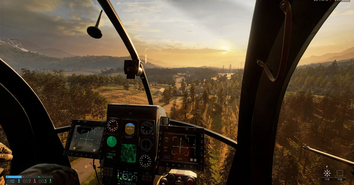 Cockpit view from a WARDOGS helicopter flying over forested hills at sunset