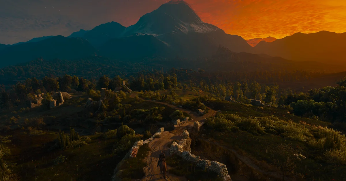 A sunset over rolling hills and forests in an official The Witcher 3 screenshot