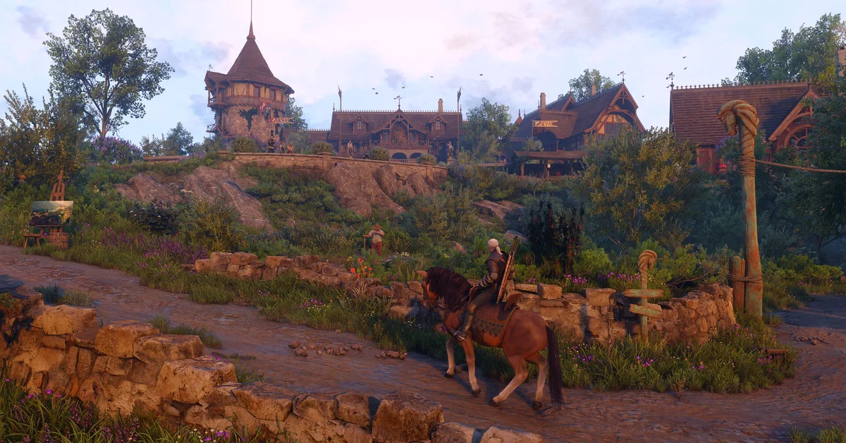 Geralt on horseback in a sunny village in Letten in an official The Witcher 3 Songs of the Past screenshot