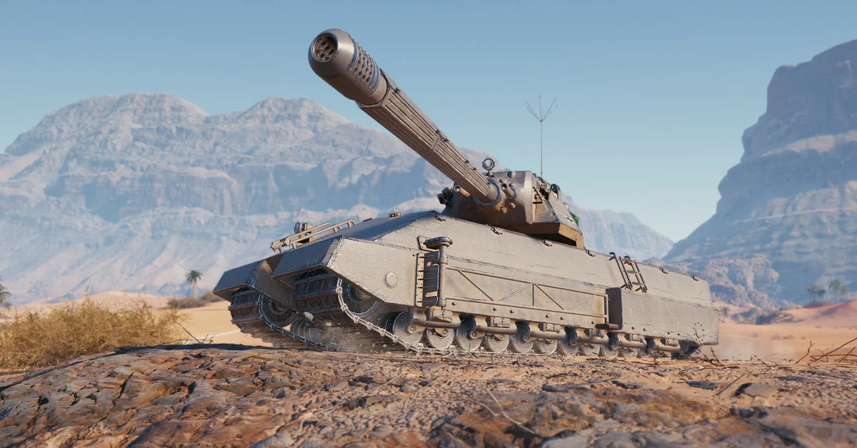 A heavy tank with a long gun parked on a rocky desert ridge in World of Tanks