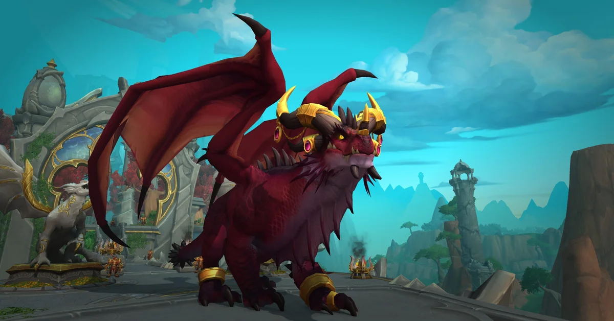 A large red dragon with gold horn rings standing on a stone terrace in World of Warcraft