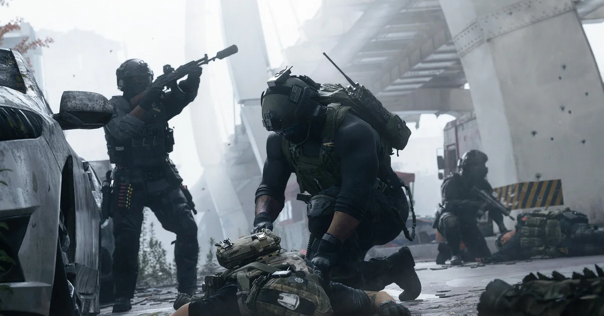 A DMZ operator kneels over a downed squadmate under a highway overpass while a teammate covers them in Modern Warfare 4
