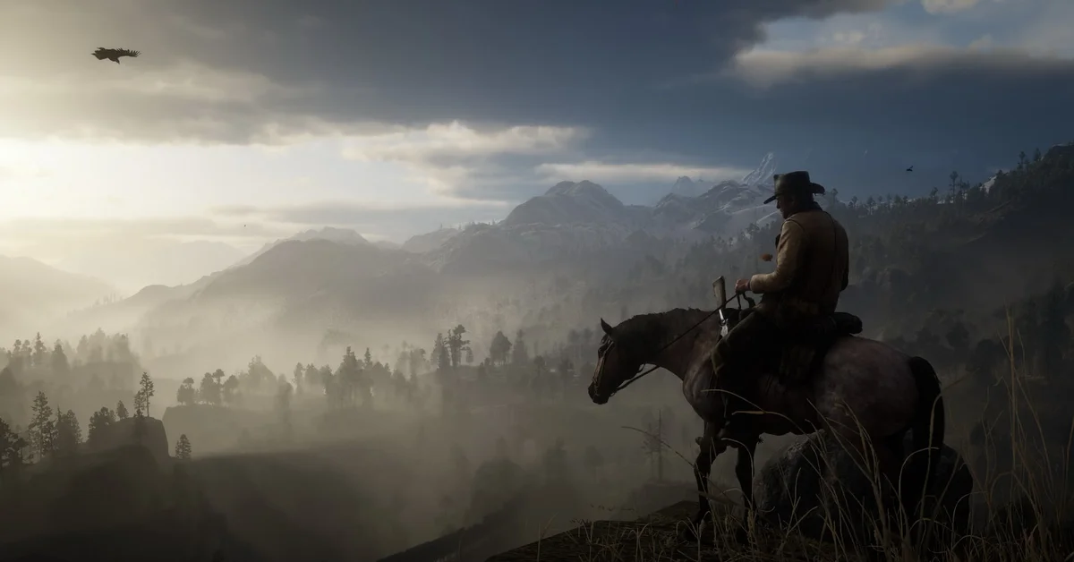 A rider on horseback looking out over misty forested mountains in Red Dead Redemption 2