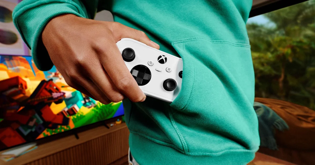 A player slips the white Xbox Nano Controller into a hoodie pocket in front of a TV